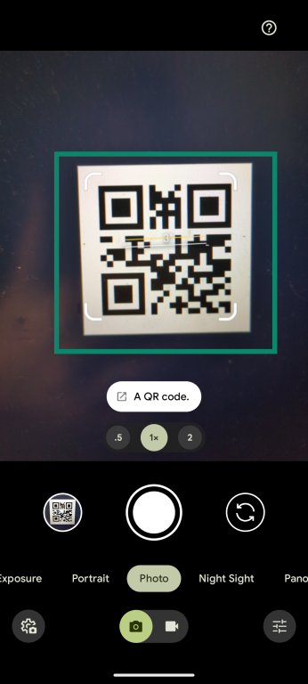 An Android smartphone screenshot, showing the camera app being used to scan a QR code.